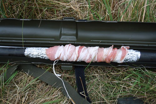 Bacon wrapped around aluminum foil wrapped around a machine gun barrel.