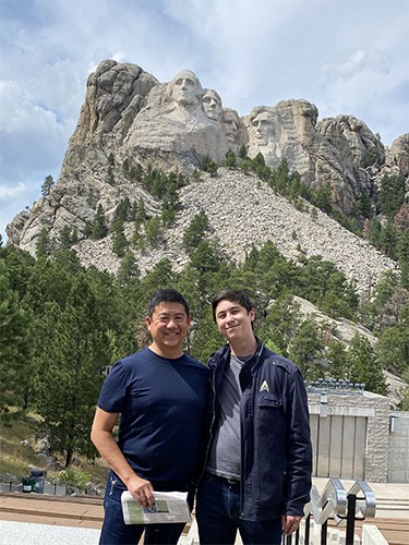Tony and Andrew standing in front of Mount Rushmore
