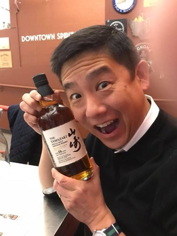 Tony with a big smile, holding a bottle of Yamazaki 18 Mizunara