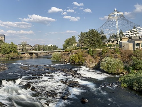 Water fall/rapids in the foreground, pyramid shaped lattice pavilion on the right back