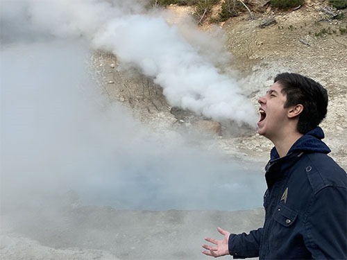 Andrew with steam billowing out of the ground behind him, looking like it is coming from his mouth.