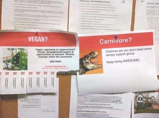 Photo of two posters on a corkboard. One is for a Vegan support group. The other is a parody saying "Carnivore? Chances are you don't need some wimpy support group. Keep being AWESOME!"