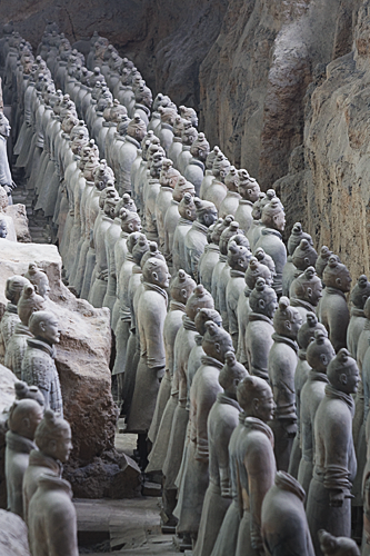 Rows and rows of terracotta soliders, viewed from the side.