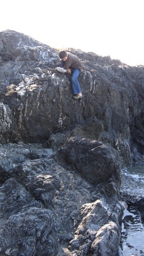 Andrew climbing down a pretty big rock.