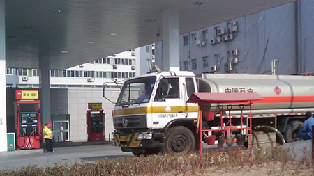 Gas station in Beijing with paltry fire fighting gear next to a tanker truck.