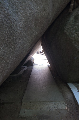 Passageway under two huge boulders.